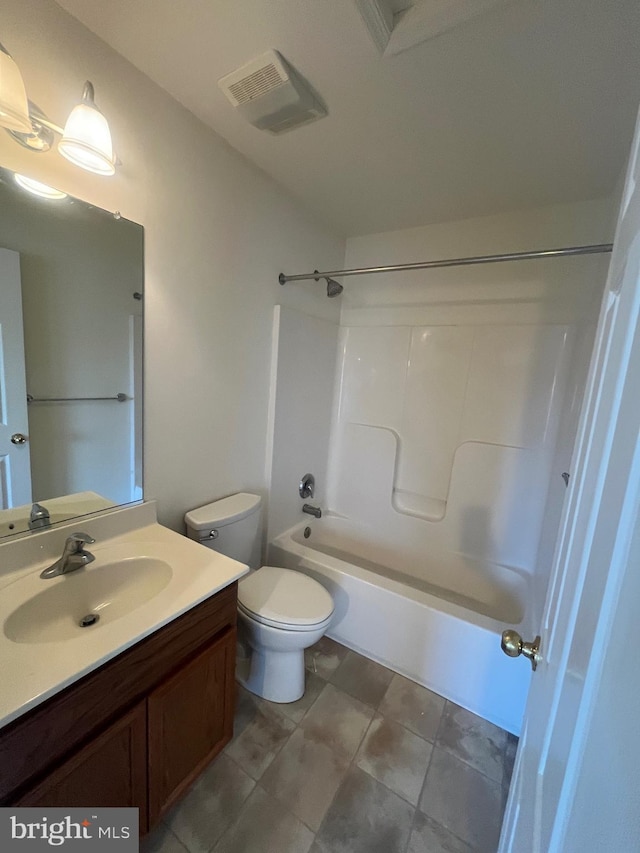 full bathroom featuring toilet, vanity, and tub / shower combination