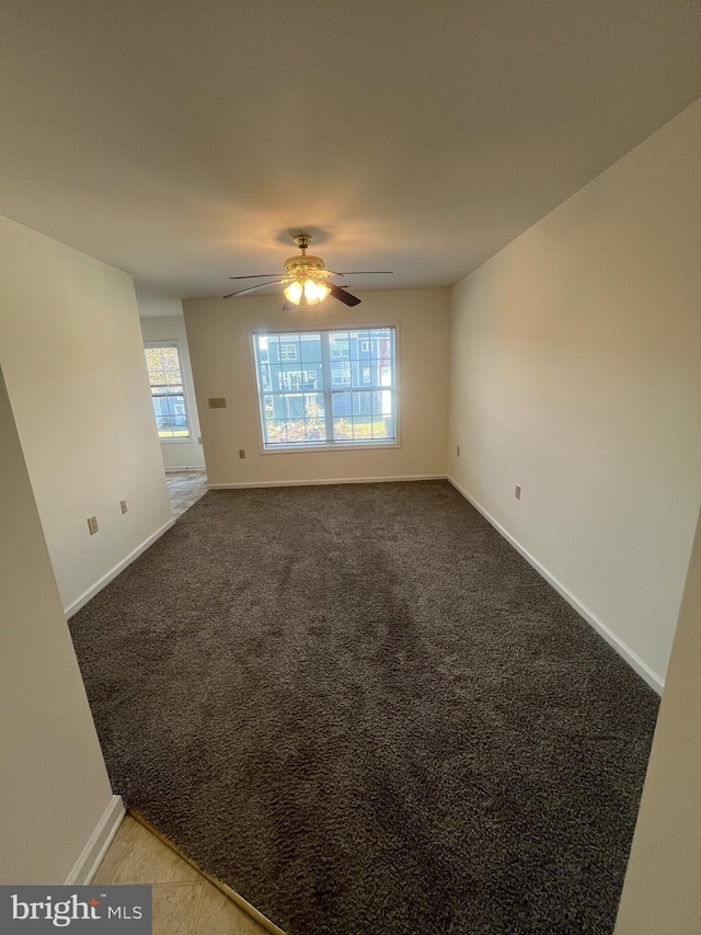 carpeted empty room featuring ceiling fan