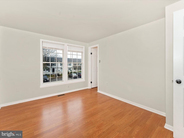 spare room with light wood-type flooring