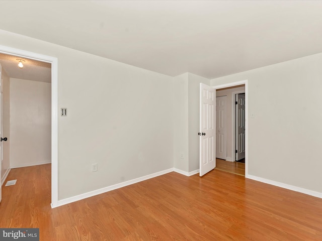 unfurnished room with light hardwood / wood-style floors