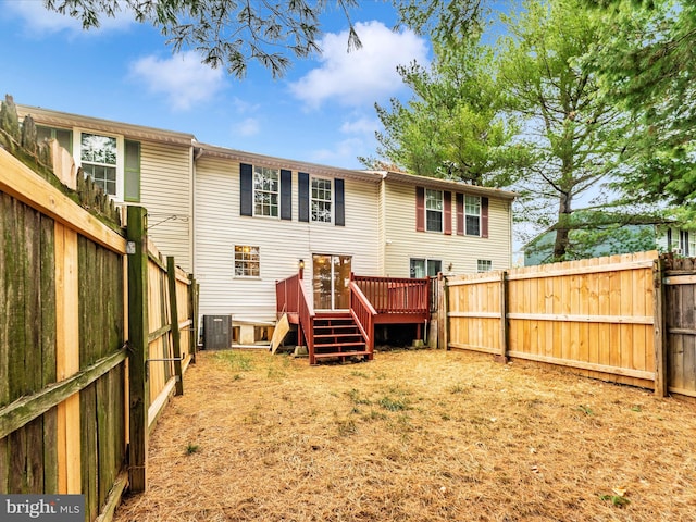 rear view of property featuring central air condition unit and a wooden deck