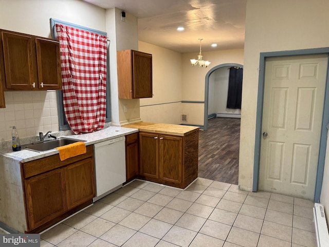 kitchen with sink, dishwasher, an inviting chandelier, light hardwood / wood-style floors, and pendant lighting