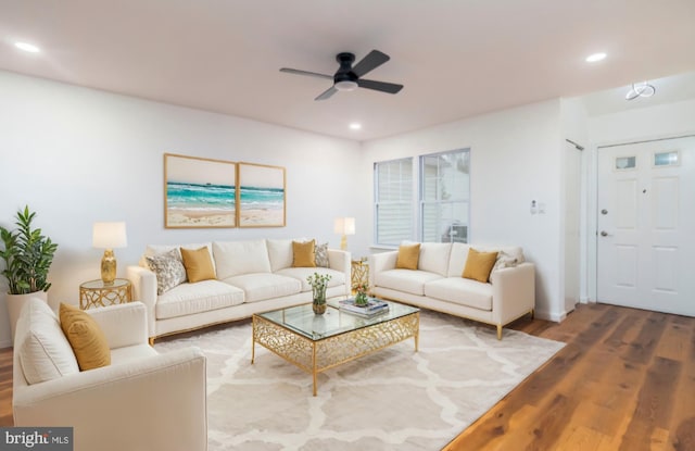 living room featuring hardwood / wood-style flooring and ceiling fan