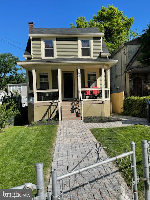 view of front of house with a front lawn and a porch