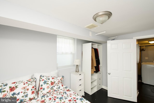 bedroom with dark hardwood / wood-style floors