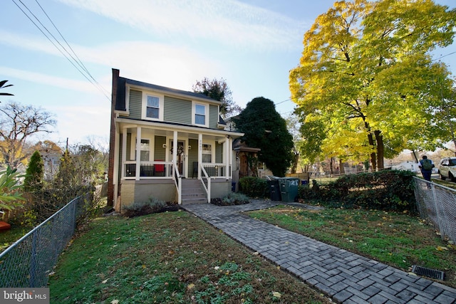 view of front of property with a porch and a front yard