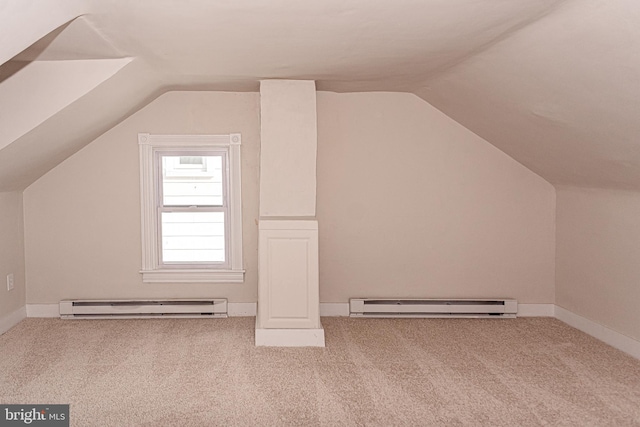 bonus room with light colored carpet, baseboard heating, and vaulted ceiling