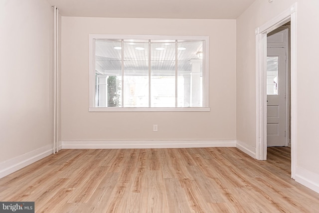 spare room with light hardwood / wood-style flooring