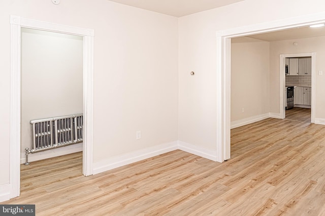 spare room featuring light wood-type flooring