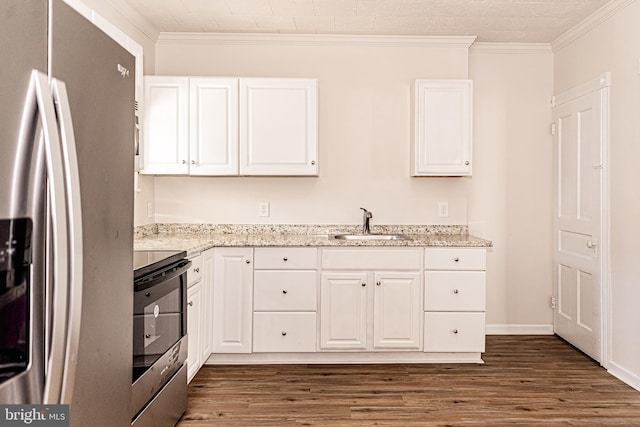 kitchen featuring crown molding, white cabinetry, stainless steel appliances, and dark wood-type flooring