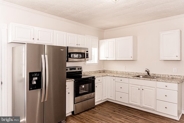 kitchen with appliances with stainless steel finishes, white cabinetry, dark wood-type flooring, and sink