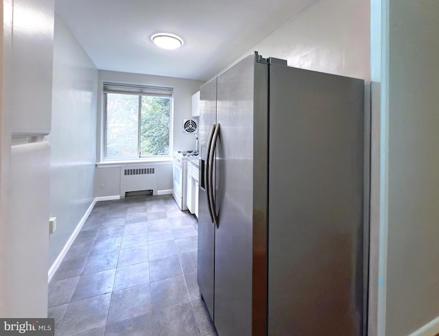 kitchen featuring tile patterned floors, radiator, and white appliances