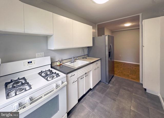 kitchen with stainless steel fridge with ice dispenser, white gas stove, white cabinetry, and sink