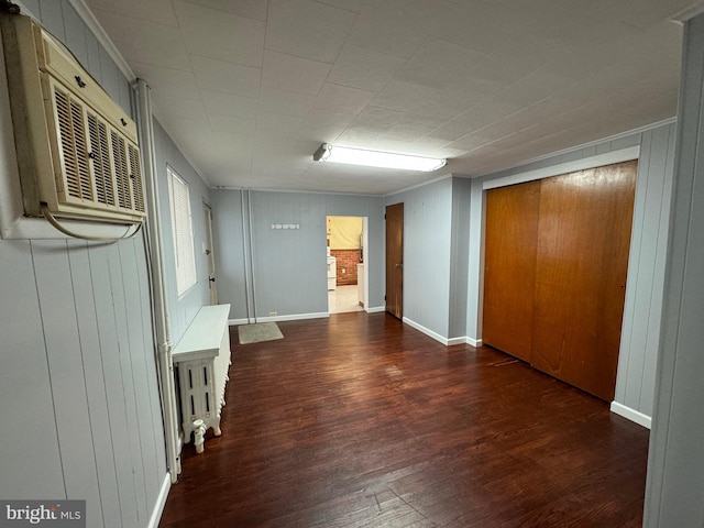 corridor with dark hardwood / wood-style flooring