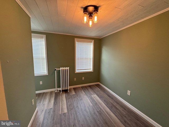 empty room with a wealth of natural light, radiator heating unit, wooden ceiling, and wood-type flooring