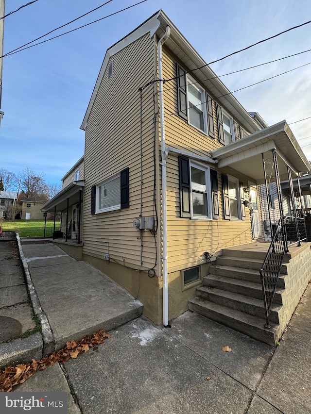 view of side of home with a porch