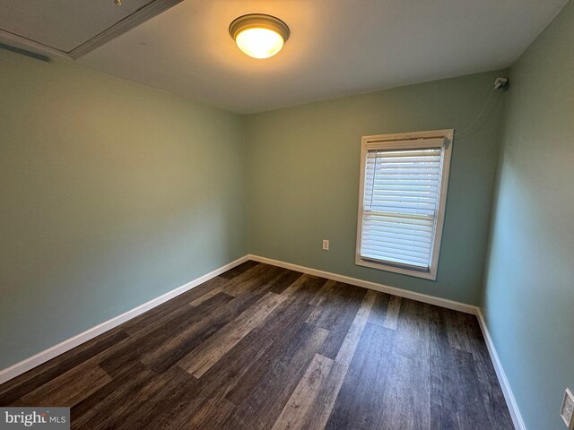 empty room with dark hardwood / wood-style floors