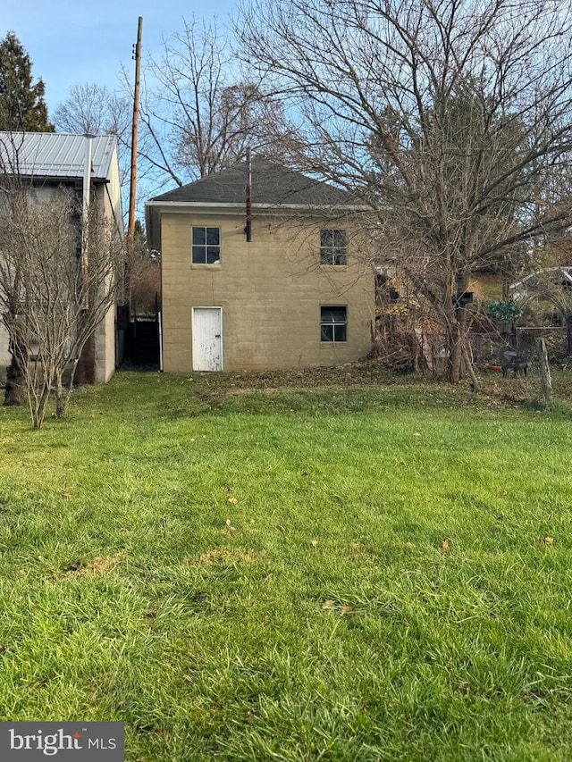 view of home's exterior with a lawn