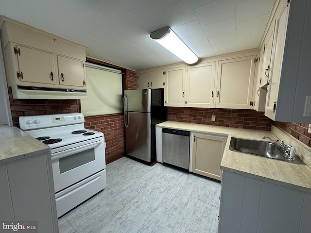 kitchen featuring cream cabinetry, appliances with stainless steel finishes, and sink