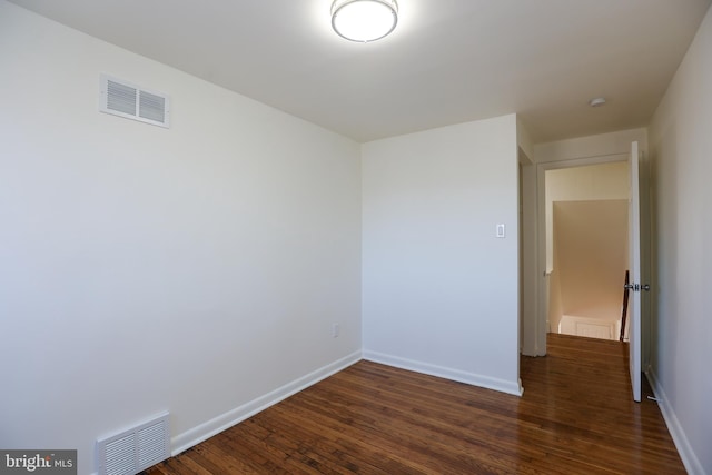 unfurnished room featuring dark hardwood / wood-style flooring