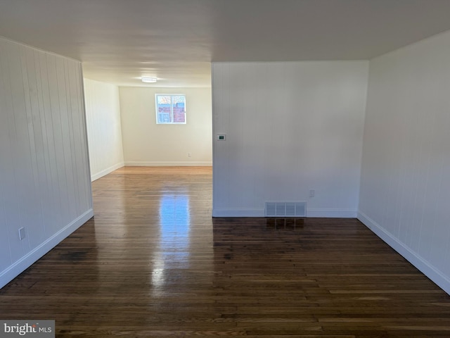 unfurnished room featuring dark wood-type flooring