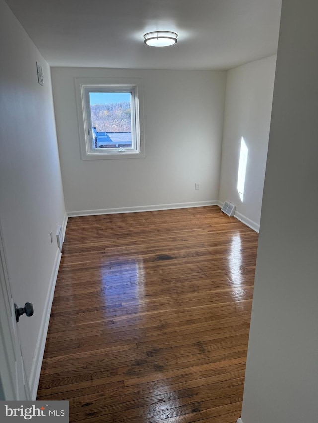 spare room with dark hardwood / wood-style flooring