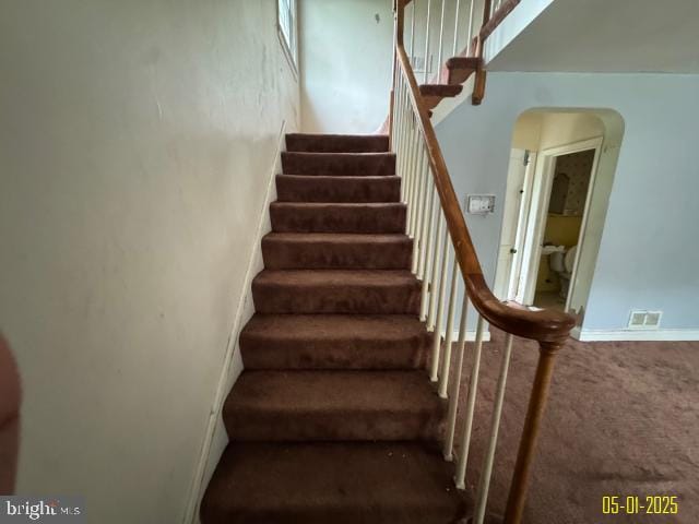 6410 Laurel Dr, Gwynn Oak, MD 21207 - staircase with arched walkways and carpet flooring