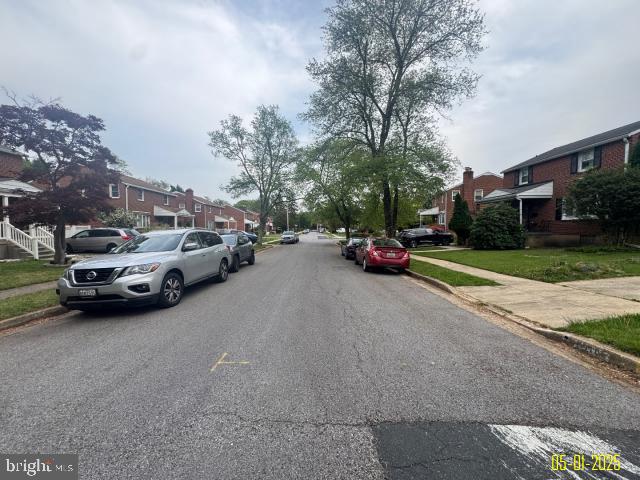6410 Laurel Dr, Gwynn Oak, MD 21207 - view of asphalt street with sidewalks, a residential view, and curbs