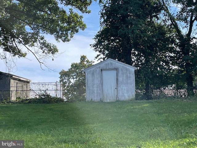 view of outbuilding with a yard