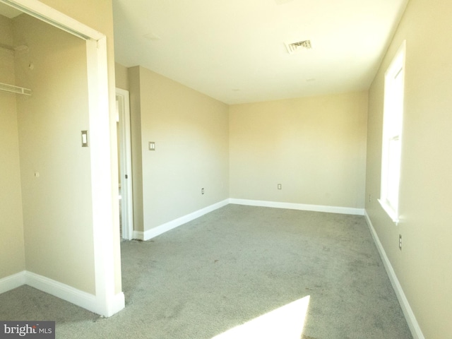 empty room featuring light carpet