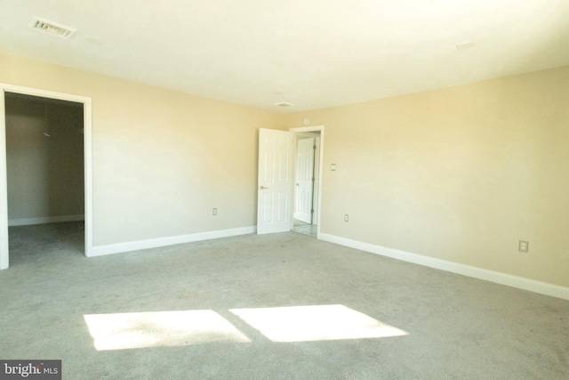 unfurnished room featuring light colored carpet