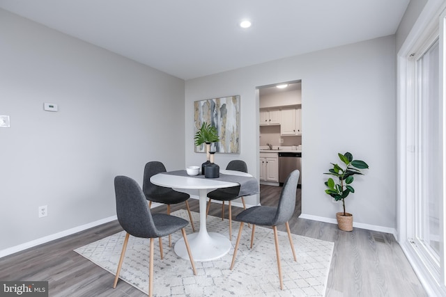 dining room featuring hardwood / wood-style flooring and sink