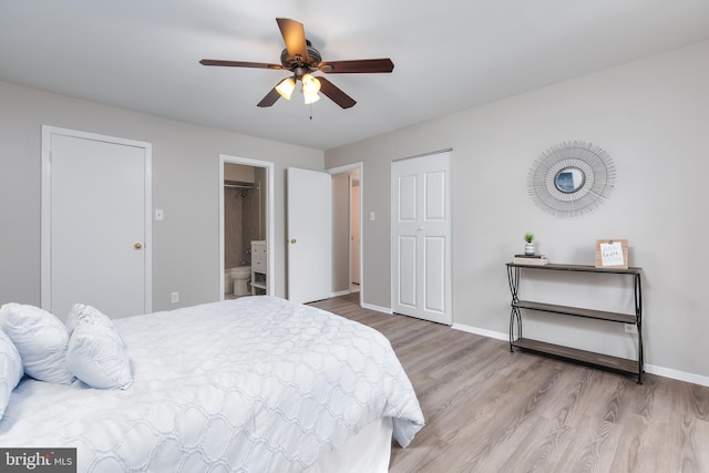 bedroom featuring ceiling fan, light wood-type flooring, and ensuite bathroom