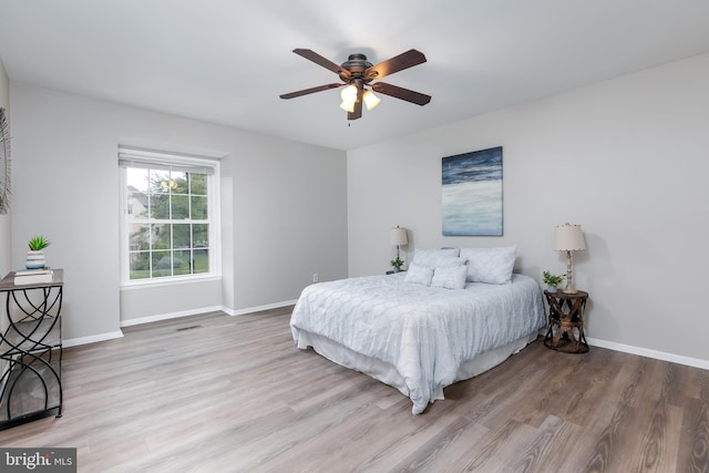 bedroom with ceiling fan and hardwood / wood-style floors