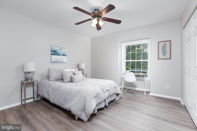 bedroom featuring a closet, hardwood / wood-style floors, and ceiling fan