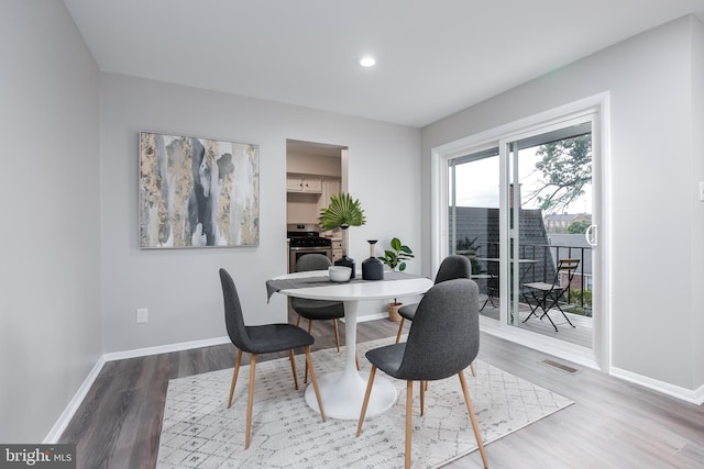 dining space with hardwood / wood-style flooring