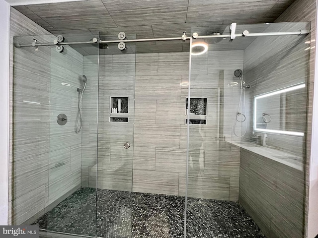 bathroom with a shower with shower door