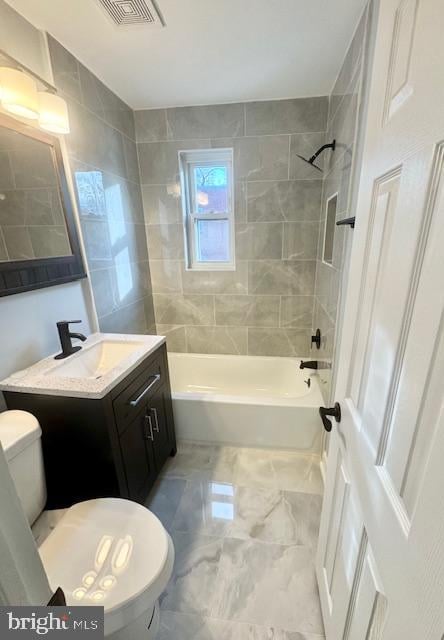 full bathroom with vanity, toilet, and tiled shower / bath