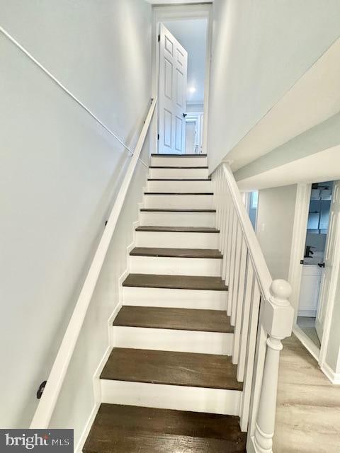 staircase with hardwood / wood-style flooring