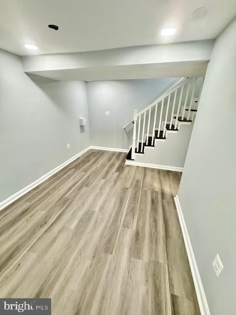 basement with hardwood / wood-style flooring