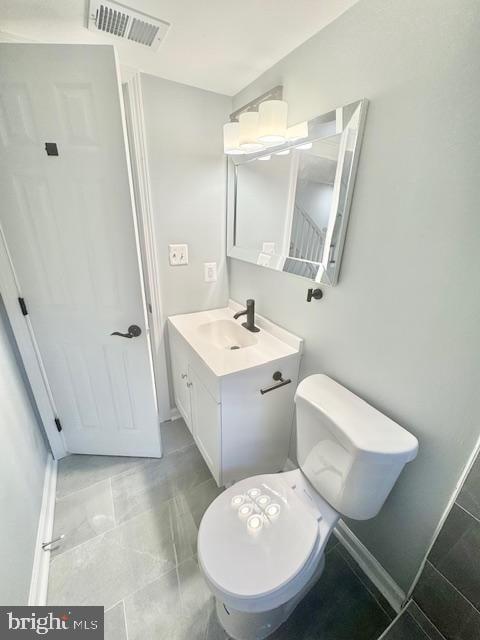 bathroom featuring vanity and toilet