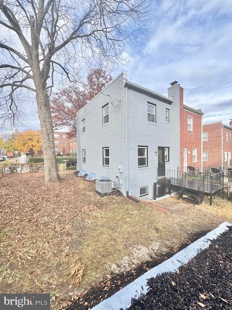 view of side of property with central AC