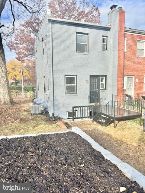 back of property featuring central AC unit