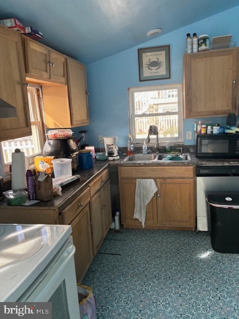 kitchen featuring white range oven, vaulted ceiling, stainless steel dishwasher, and sink