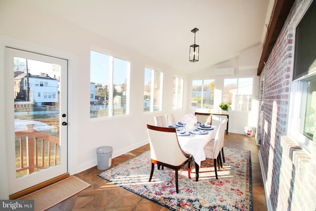 sunroom / solarium featuring a wall mounted air conditioner and vaulted ceiling