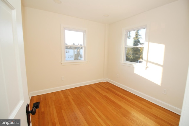 empty room featuring hardwood / wood-style floors and a healthy amount of sunlight