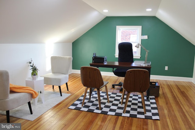 office area with light hardwood / wood-style floors and lofted ceiling