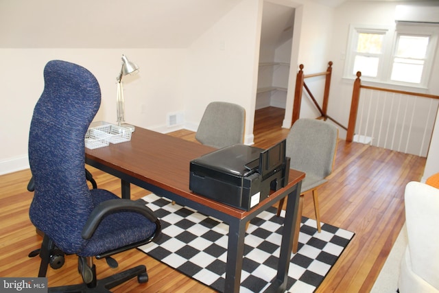 home office with wood-type flooring and vaulted ceiling