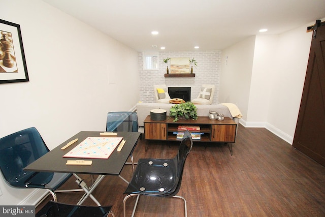 dining room featuring a fireplace and dark hardwood / wood-style flooring