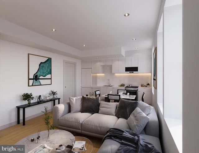 living room with sink and light hardwood / wood-style flooring